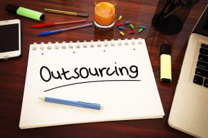 Outsourcing - handwritten text in a notebook on a desk - 3d render illustration.